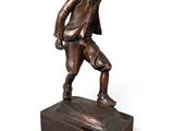 bronze statue of a man with a hat on his head