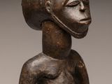 an image of a wooden statue of a woman