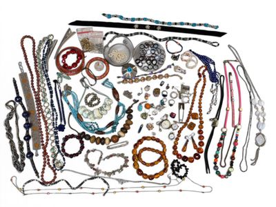 many different types of necklaces and bracelets laid out on a table