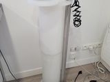 an image of a room with a white toilet and a black and white toilet paper dispenser