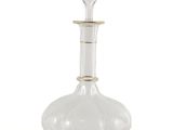 clear glass decanter with gold trim on top of a white background
