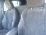 two seats in the back of a car that are grey