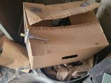 a cardboard box sitting on top of a metal bucket
