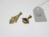 two pieces of gold and blue glass pendants with a price tag
