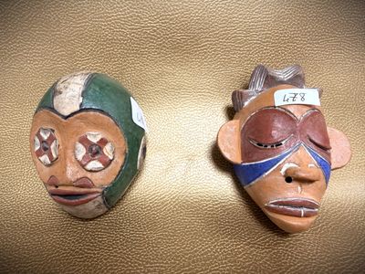 two masks that are sitting on a table