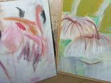 two paintings of flowers are sitting next to each other on the floor