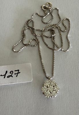 a close up of a necklace with a tag on it