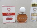 a close up of a bottle of perfume next to a box of perfume