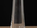 a glass vase sitting on a table with a black background