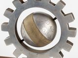 a metal object with a clock on top of it on a table