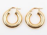 a pair of gold hoop earrings on a white background