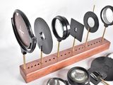 a wooden stand with a lot of different types of magnifyings on it
