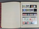 an open book with stamps on it sitting on a table