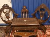 a wooden table and chairs in a room with blue walls