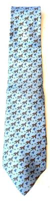 blue and black patterned tie laying on a white surface