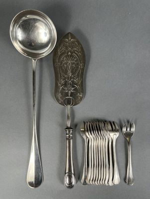 a lot of silver spoons and silverware on a table