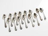 a lot of spoons that are lined up on the table