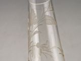 a clear glass vase with a floral design on it