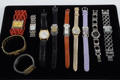 a black tray with a variety of watches and bracelets