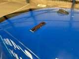 a remote control on the hood of a blue car