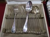 silverware in a box with spoons and spoons on a red table