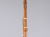 a close up of a wooden clarinet on a white surface