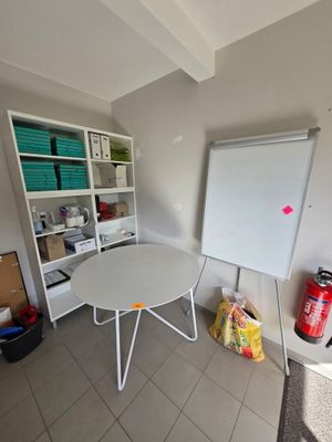 an image of a room with a whiteboard and a white table