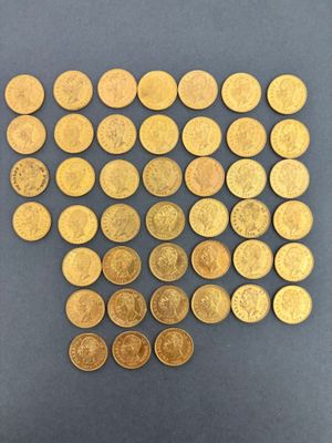 a pile of gold coins sitting on top of a blue surface
