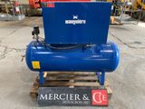 an air compressor sitting on top of a wooden pallet in a warehouse
