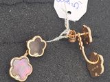 pair of pink and gold flower earrings on a black cloth