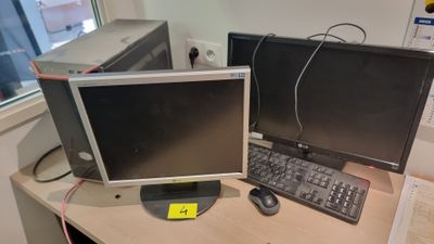 two computer monitors sitting on a desk with a keyboard and mouse