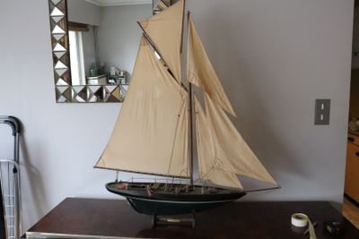 a small sailboat on a dresser in a room