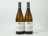 two bottles of wine sitting next to each other on a table