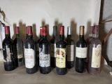 several bottles of wine are lined up in a row on a table
