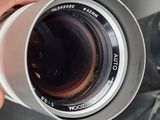 a person holding a camera lens in their hand