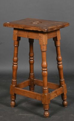 an old wooden stool with turned legs and a wooden seat
