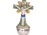 ceramic figurine of a crucifix with a cross on top of it