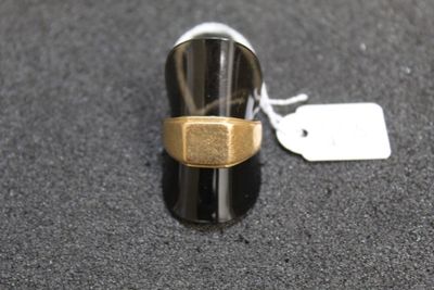 a silver and gold ring with a tag on it