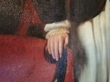 a painting of a woman sitting on a red couch