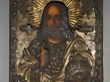 a picture of a metal plaque with a picture of jesus on it
