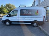 the van is parked in the parking lot outside of the building