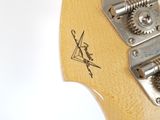 a close up of an electric guitar with a wooden neck