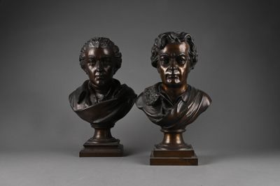 a pair of bronze busts of a man and a woman