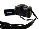 a camera with a camera strap attached to it ' s body