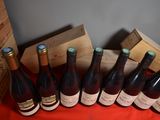 several bottles of wine sitting on a table next to a wooden box