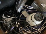 a pile of wires and cords in a bin on the floor