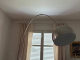 an image of a living room with a couch and a lamp