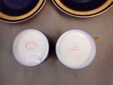 two cups and saucers sitting on a table