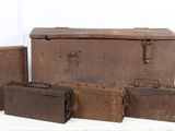 several old suitcases are lined up on a white surface