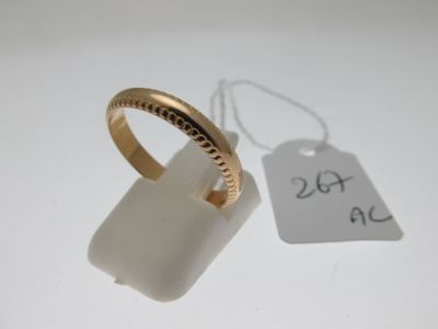 an image of a gold ring with a tag attached to it